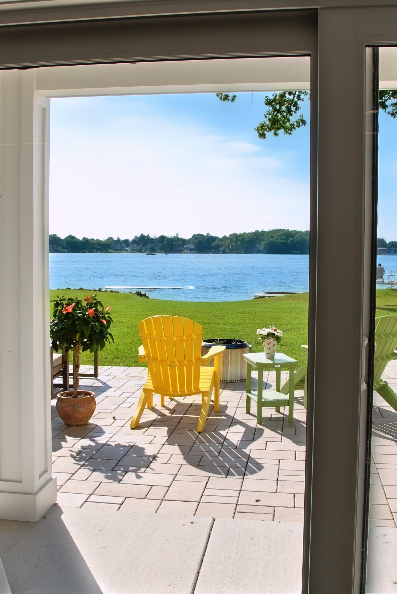 The Burlington lakehouse great room with its stone hearth and lake views