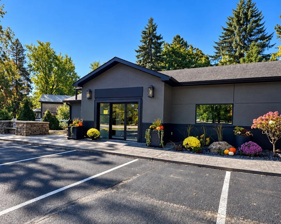 The Monien Construction office on a clear fall day, with mums and pumpkins at the entrance