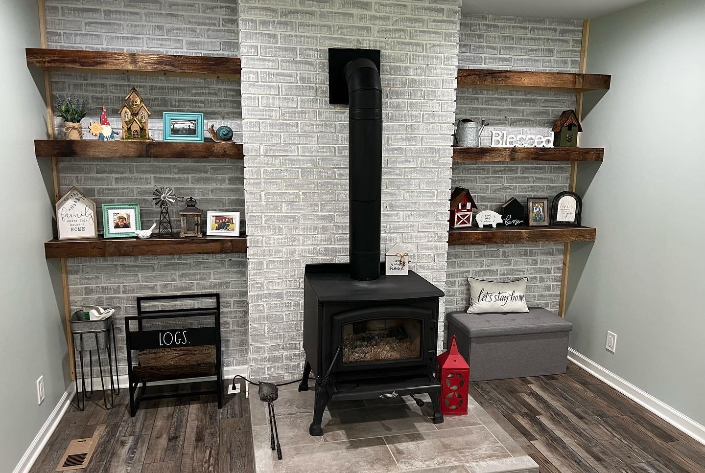 Whitewashed brick hearth with floating wood shelves