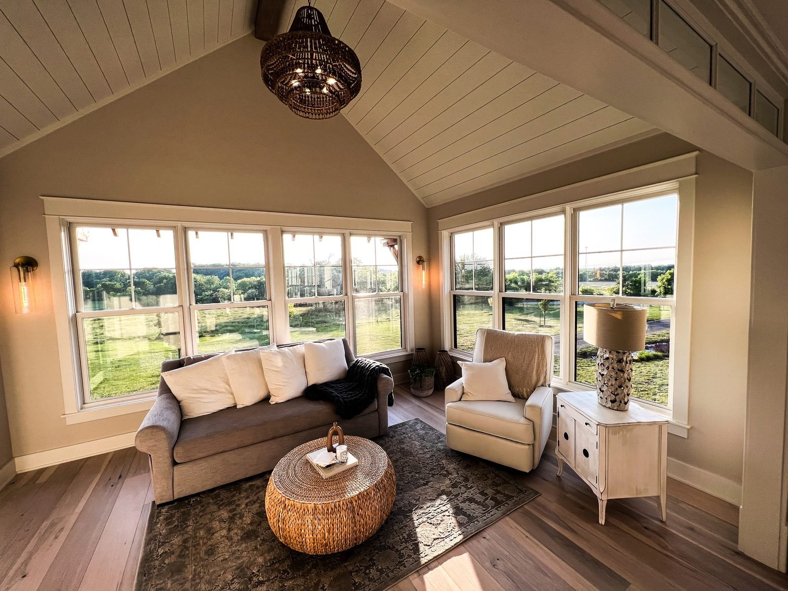 Bright sitting room with wide windows overlooking the countryside