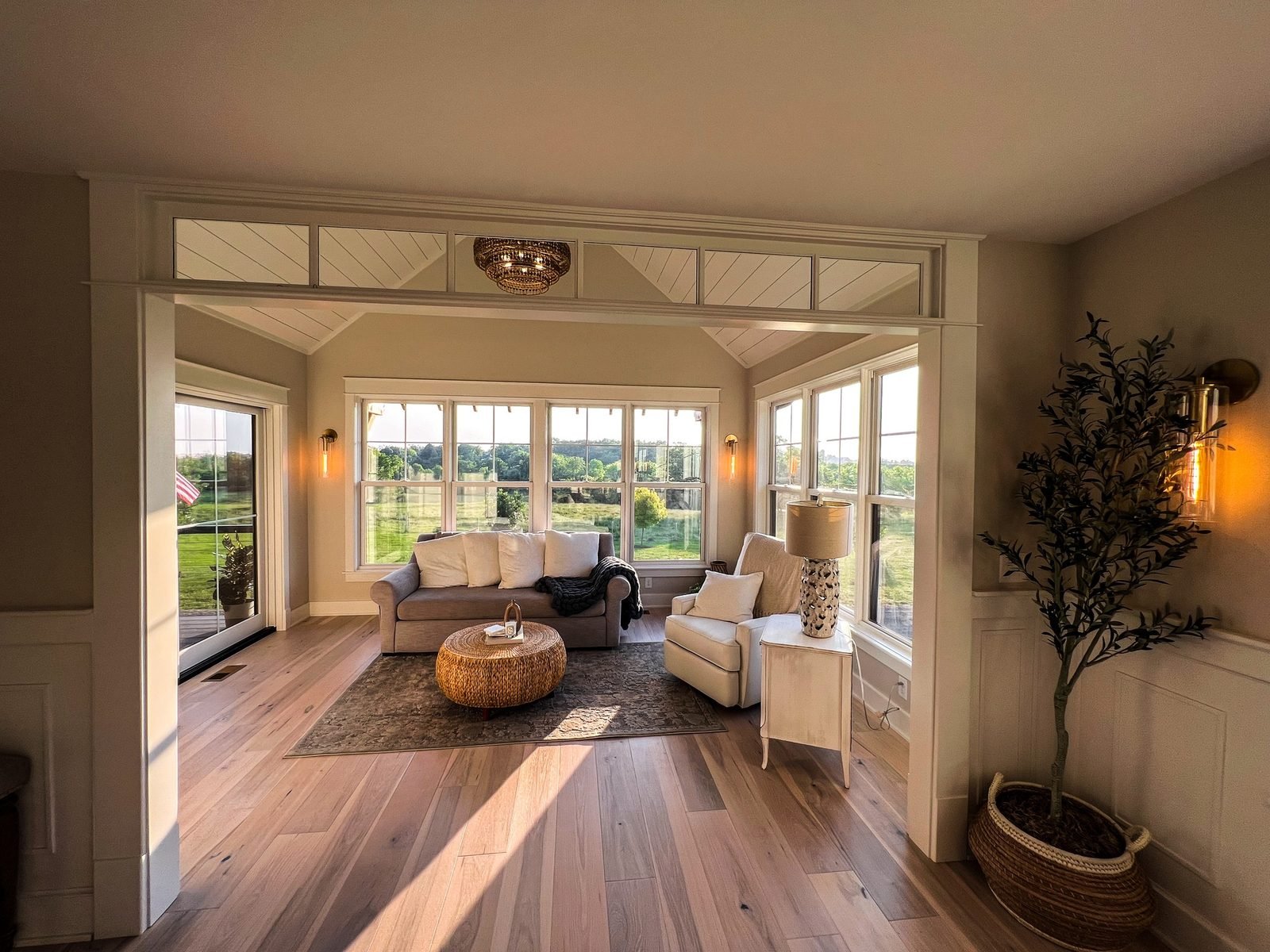 Sunroom with transom windows overlooking open countryside