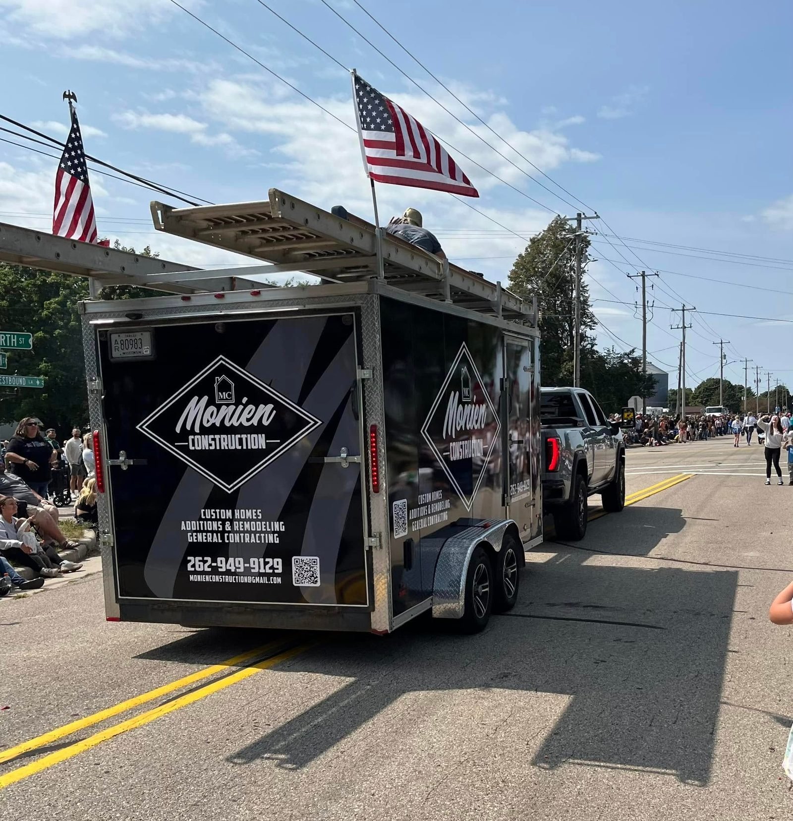 The Monien Construction trailer in a local parade with American flags